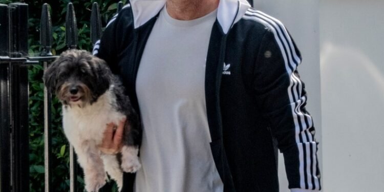 Chelsea legend Frank Lampard carries adorable puppy while out for a walk near his London home